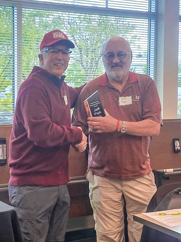 Tom Knappenberger, left, presents the Bud Pasmore Volunteer Achievement Award to Jeff Fish.