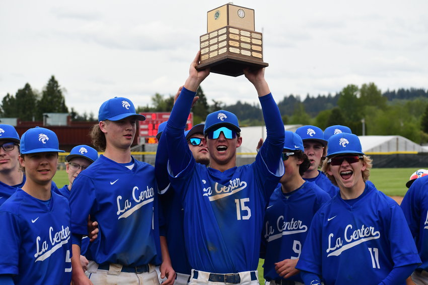 The La Center High School baseball team cheers as they hoist their championship trophy.