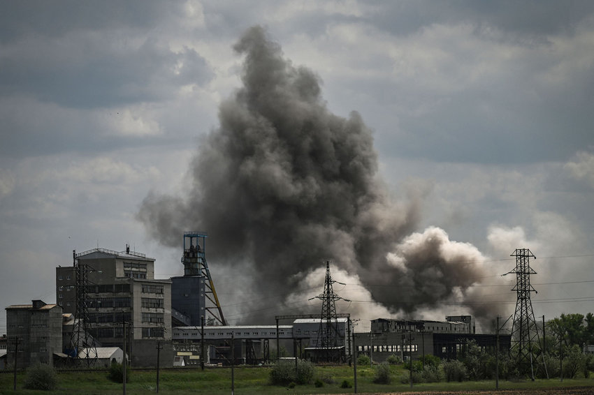 Smoke and dirt ascends after a strike at a factory in the city of Soledar at the eastern Ukranian region of Donbas on May 24, 2022, on the 90th day of the Russian invasion of Ukraine. (Aris Messinis/AFP via Getty Images/TNS)