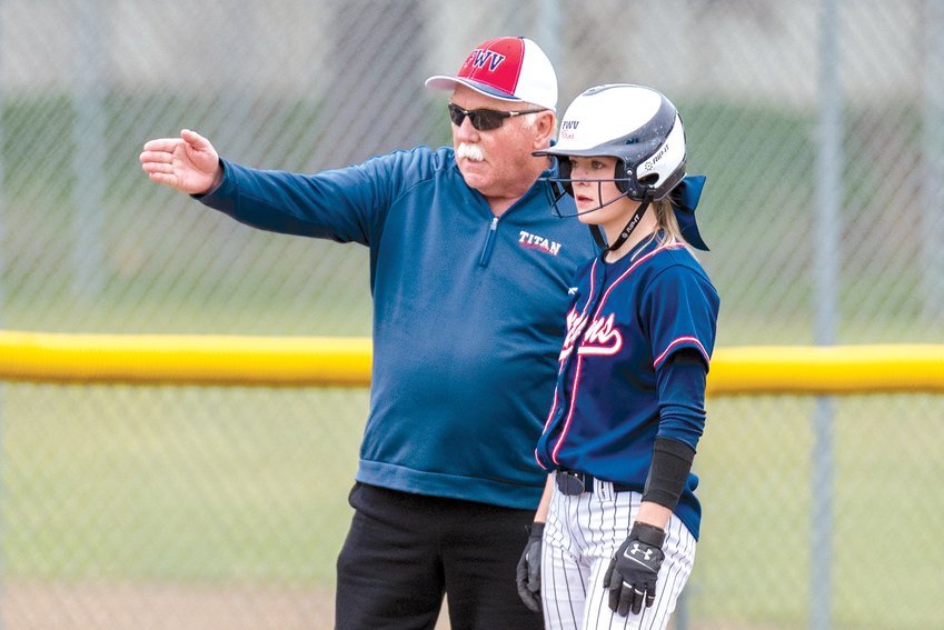 Pe Ell-Willapa Valley coach Ken Olson talks to Payton Peterson on third base during a home game against Forks on April 1.