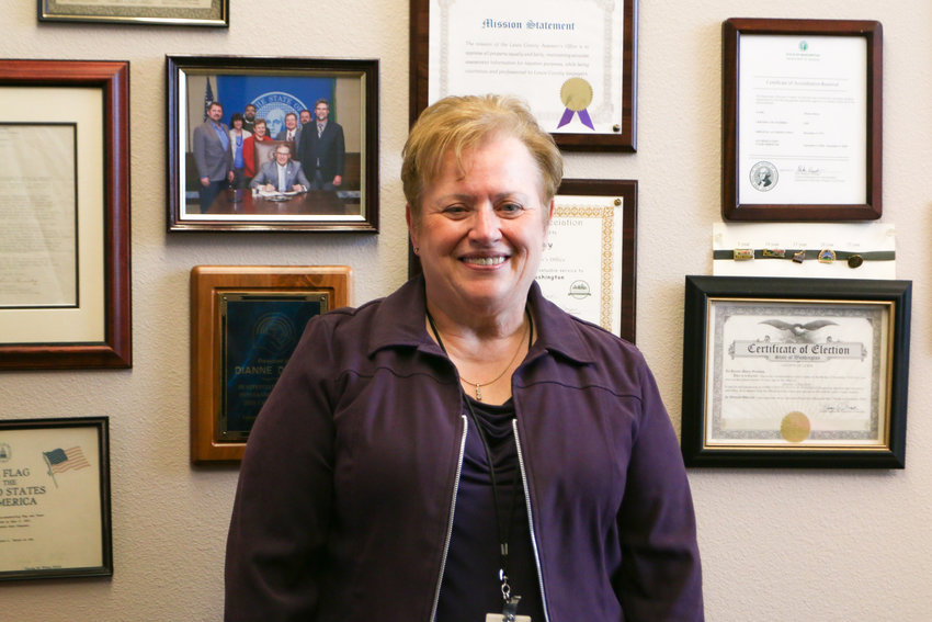 Dianne Dorey stands in front of her wall of achievements and awards over the years serving as the Lewis County Assessor since March of 1998.