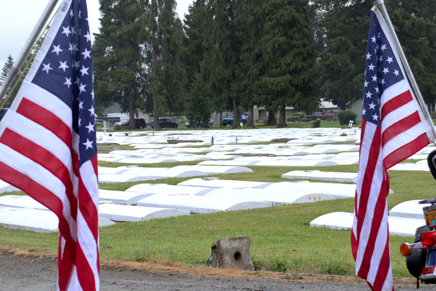 FILE PHOTO &mdash; Flags mark veterans&rsquo; burial sites at Greenwood Memorial Park during a rededication ceremony in May 2022.
