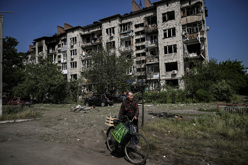 An eldery man walks by a damaged appartment building after a strike in the city of Slovyansk at the eastern Ukrainian region of Donbas on May 31, 2022, amid Russian invasion of Ukraine. (Aris Messinis/AFP via Getty Images/TNS)