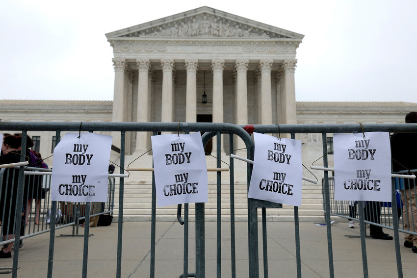 Pro-choice signs hang on a police barricade at the U.S. Supreme Court Building on Tuesday, May 3, 2022, in Washington, D.C. (Anna Moneymaker/Getty Images/TNS)