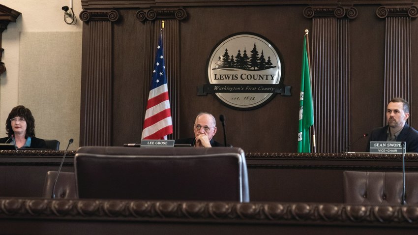 Lewis County commissioners, from left, Lindsey Pollock, Lee Grose and Sean Swope listen during a meeting at the Lewis County Courthouse in April.