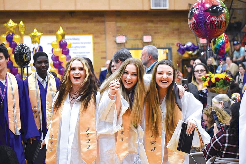 Graduates smile and lock hands while celebrating at Onalaska High School on Friday.