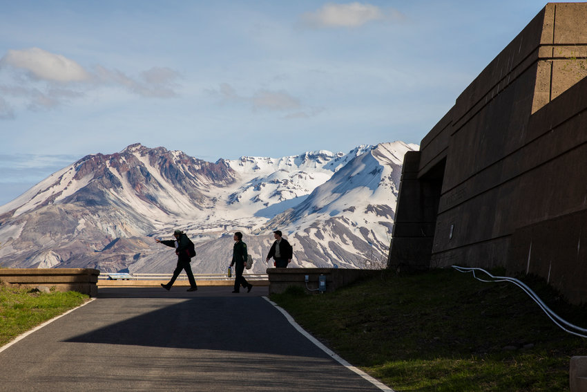 Nishan Mahdasian, Madisyn Emley and Skye Clark, seasonal Park Rangers at Johnston Ridge Observatory, walk outside in front of Mount St. Helens in June 2022.