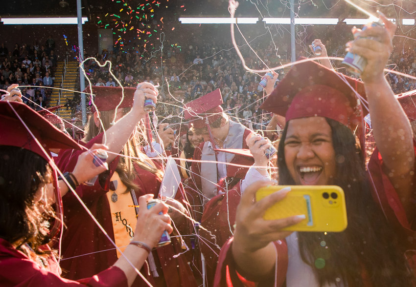 Silly String and confetti flies as W.F. West graduates celebrate at Bearcat Stadium Saturday in Chehalis.