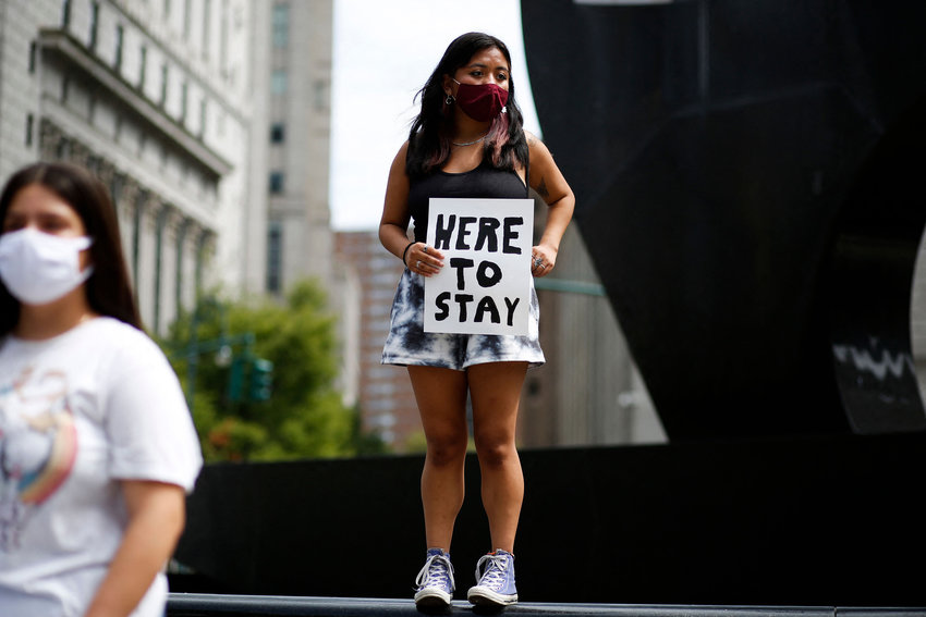 A woman holds a banner during a protest supporting DACA, Deferred Action for Childhood Arrivals, at Foley Square in New York, on Aug. 17, 2021. (Kena Betancur/AFP/Getty Images/TNS)