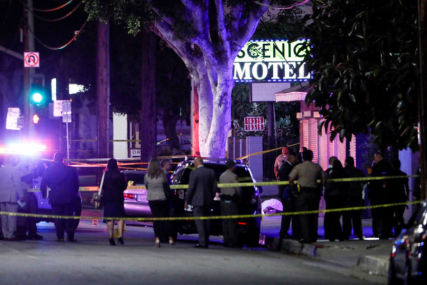 Law enforcement personnel investigate the scene after a shooting left two officers and a suspect dead Tuesday, June 14, 2022, in El Monte, California. (Robert Gauthier/Los Angeles Times/TNS)