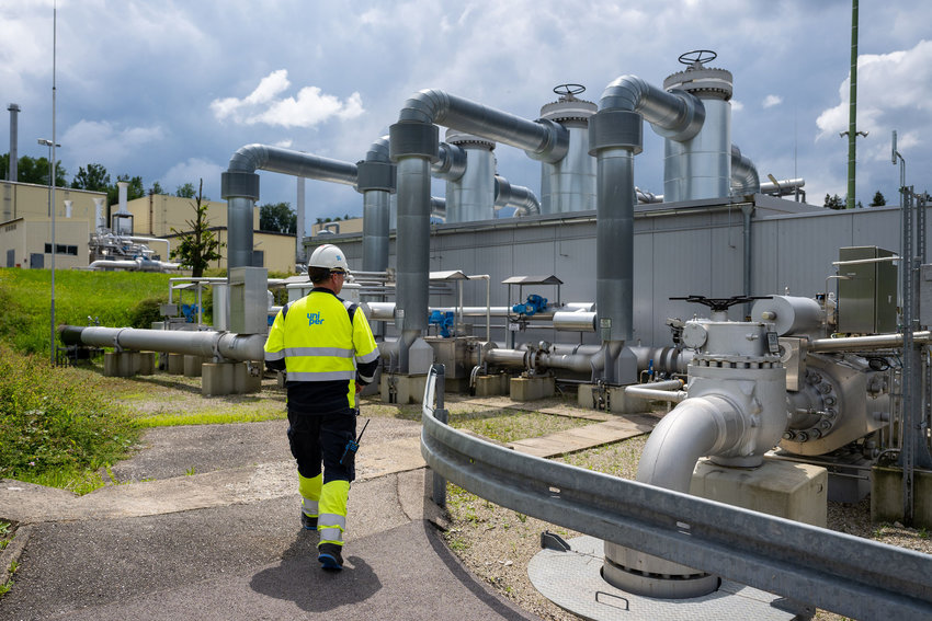 An employee of Uniper Energy Storage walks through the above-ground facilities of a natural gas storage facility  at the Uniper Energy Storage facility in Bierwang, Germany, on June 10, 2022. (Lennart Preiss/AFP/Getty Images/TNS)