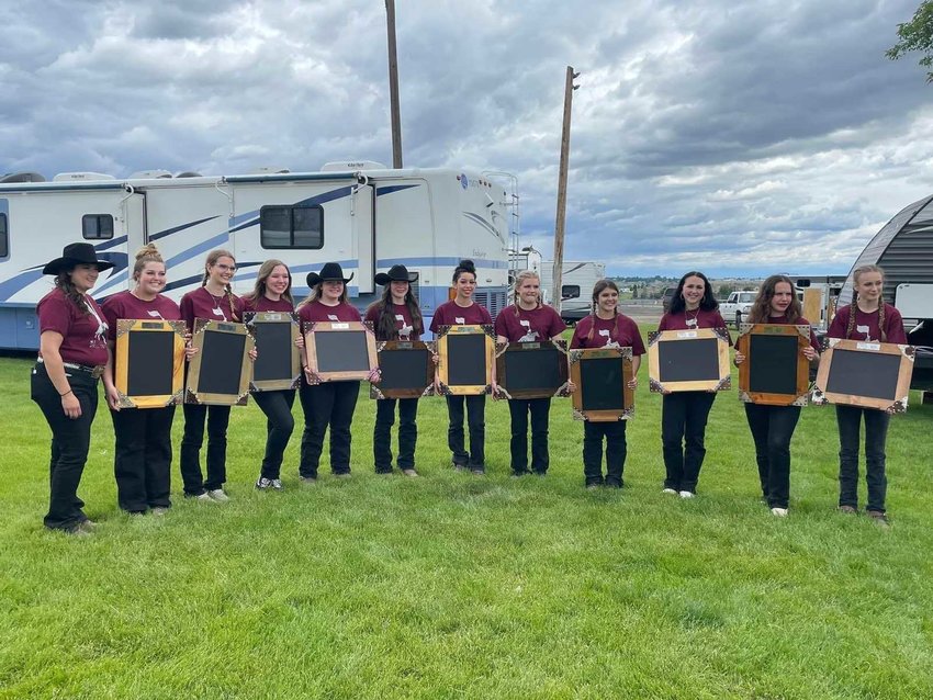 The W.F. West Equestrian Team poses for a photo with chalkboards.
