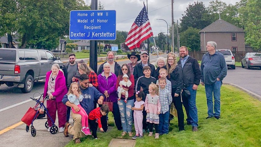 Members of Dexter Kerstetter&rsquo;s family gather under the sign dedicated to their relative.