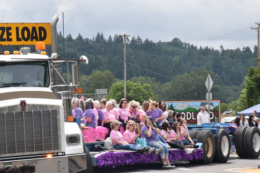 Past members of Woodland Planters Days royalty wave from the bed of a truck during the celebration&rsquo;s 100th-year parade on June 18.