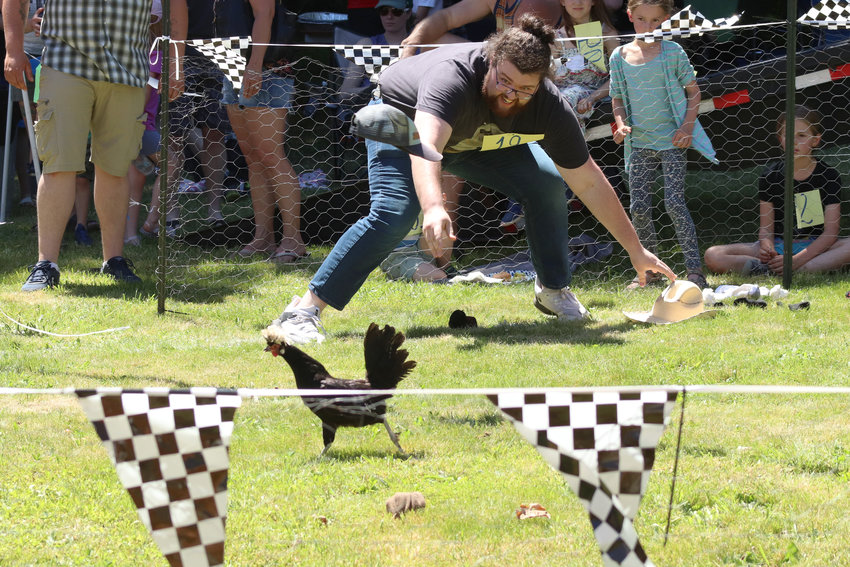 FILE PHOTO &mdash; Parker Ashton throws a cap at a chicken during Independence Valley Community Hall&rsquo;s 42nd Annual Chicken Races in Rochester in 2022.