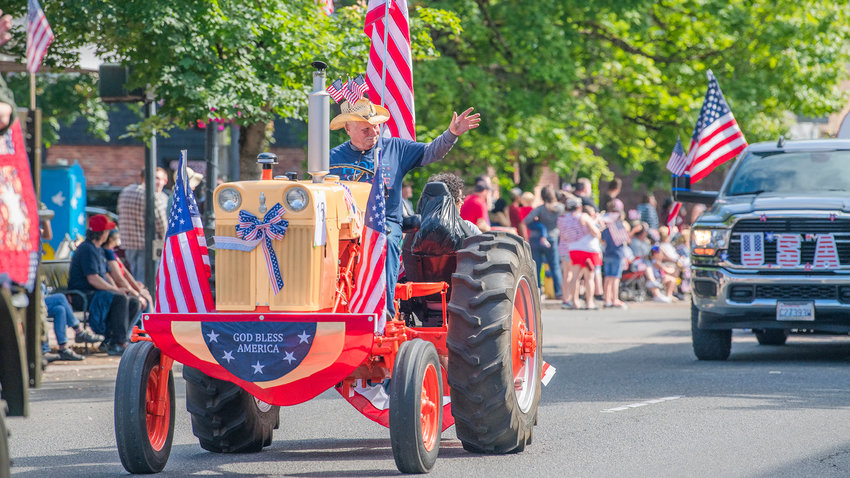 Flags are displayed on tractors and trucks traveling down South Tower Avenue in downtown Centralia in July 2022.