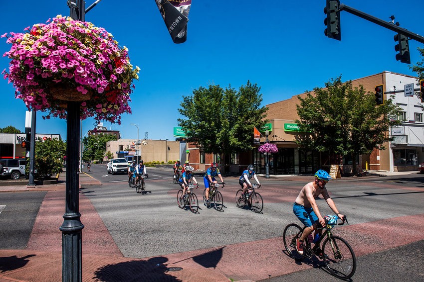 A shirtless man leads a pack of cyclists through downtown Centralia on during the annual Seattle to Portland bicycle event in 2019.
