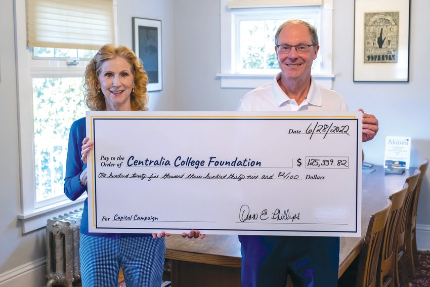 Susan and Dean Phillips hold a large check representing their donation to the Centralia College Foundation.