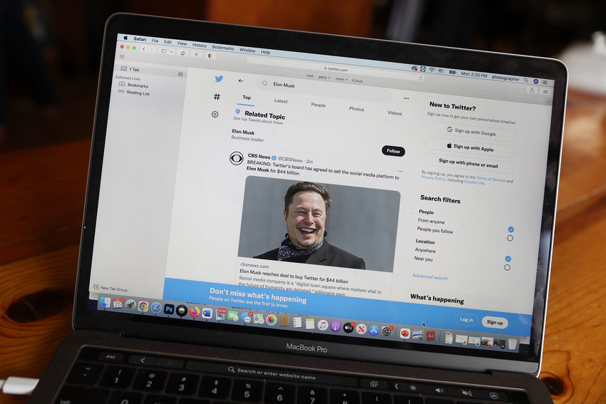 In this photo illustration, news about Elon Musk's bid to takeover Twitter is tweeted on April 25, 2022, in Chicago, after it was announced that Twitter accepted a $44 billion bid from Musk to acquire the company. (Scott Olson/Getty Images/TNS)