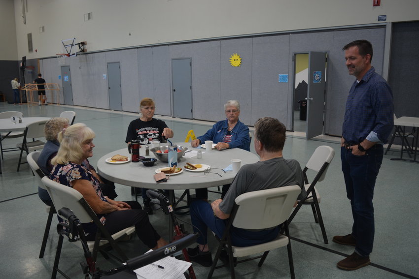 Pastor Jason Matters engages with a number of senior citizens at the Church of the Nazarene in Ridgefield on July 5 during the return of the first Meals on Wheels People lunch.