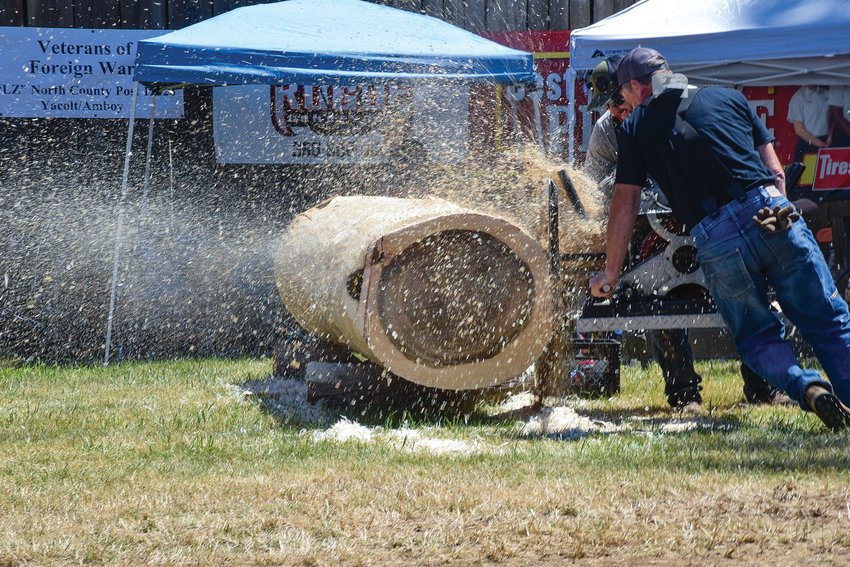 Competitors let wood shavings fly as part of the hot saw competition during the 2022 Amboy Territorial Days on July 9.