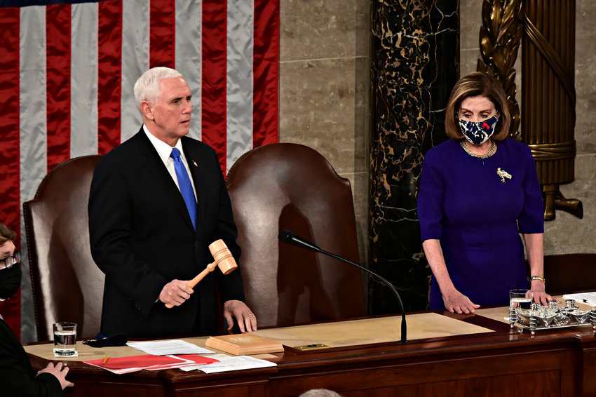 Speaker of the House Nancy Pelosi, D-CA, right, listens as Vice President Mike Pence speaks during a joint session of Congress to count the Electoral College votes of the 2020 presidential election in the House Chamber on Jan. 6, 2021, in Washington, D.C. (Erin Scott/Pool/Getty Images/TNS)
