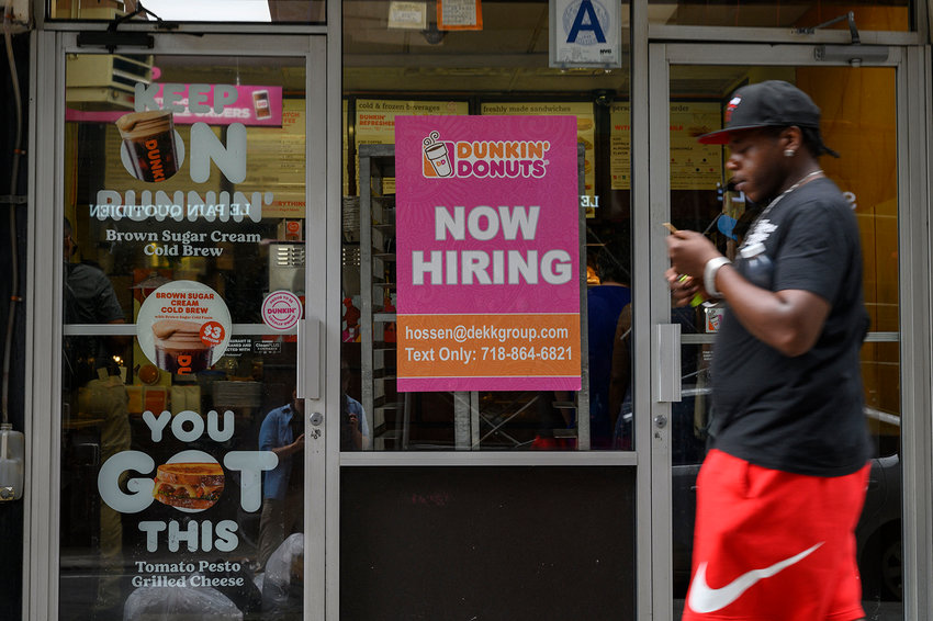 A man walks past a &quot;Now Hiring&quot; sign in New York City on July 8, 2022. (Angela Weiss/AFP via Getty Images/TNS)