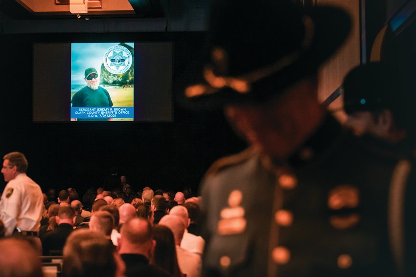 A law enforcement officer stands by the crowd gathered at a memorial service for Clark County Sheriff&rsquo;s Detective Jeremy Brown on Aug. 3, 2021.