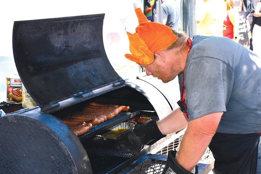 Paul Glavanits, with Original Northwest Barbecue Company, grills up meat at the Nisqually Valley Barbecue Rally in 2021. The event is set to take place again on Saturday, July 23 at Yelm City Park.