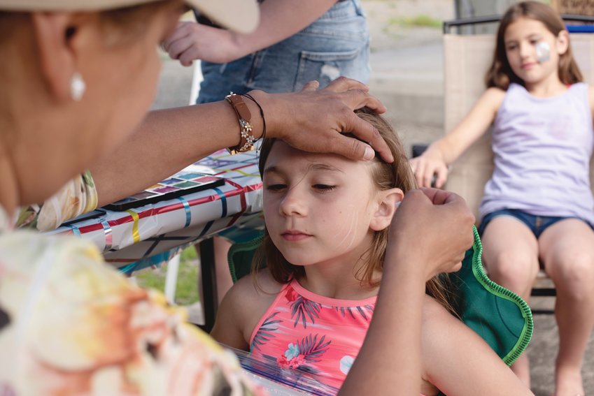 Bracelyn Story-Gaul, of Graham, prepares to get her face painted at the Mystic Enchanted Garden Festival at Yelm City Park on Saturday, July 16.