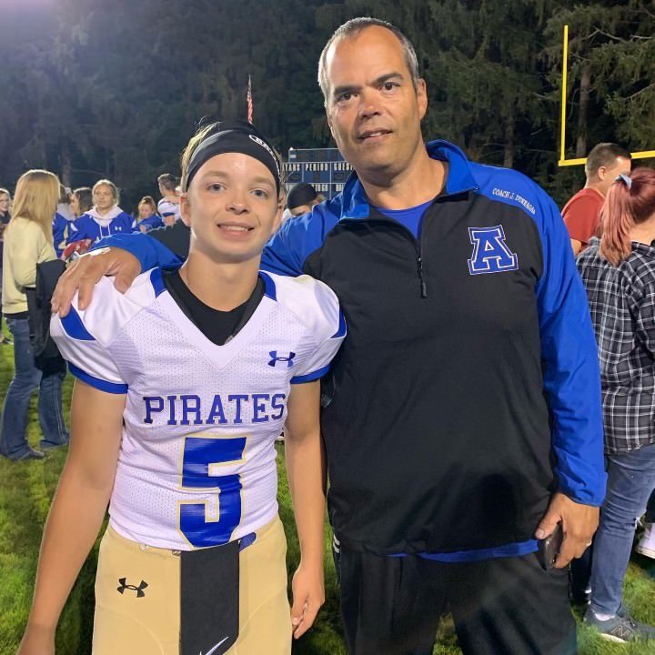 New Adna head coach Jason Dunnagan (right) poses for a photo with his son, Jaxon (left) after a Pirates game.