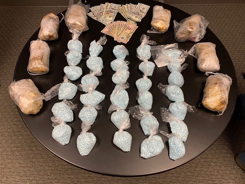 Drugs confiscated Thursday, July 14, by Longview and Cowlitz County detectives are spread out on a table. Two people in the vehicles the drug were found in have been charged in Cowlitz County Superior Court.