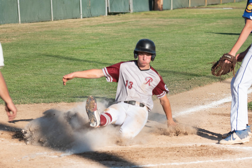 Miles Martin slides into home plate after a wild pitch for I-5 Jeep Renegades in the first round of the A American Legion state tournament in Chehalis July 23.