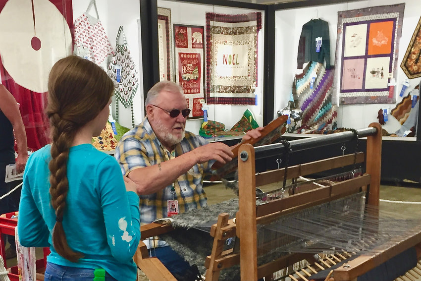 Chuck Ament demonstrates how to use a loom at the Southwest Washington Fairgrounds in this photograph provided by Jessie Erickson.