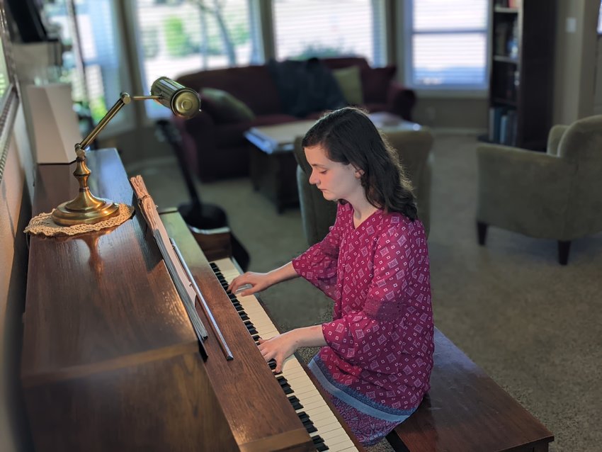 Loriellen Brittain plays the piano at her home in Battle Ground.