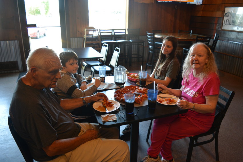 A family enjoys a pizza at Rocky&rsquo;s Pizza &amp; R Bar in Battle Ground on July 28.