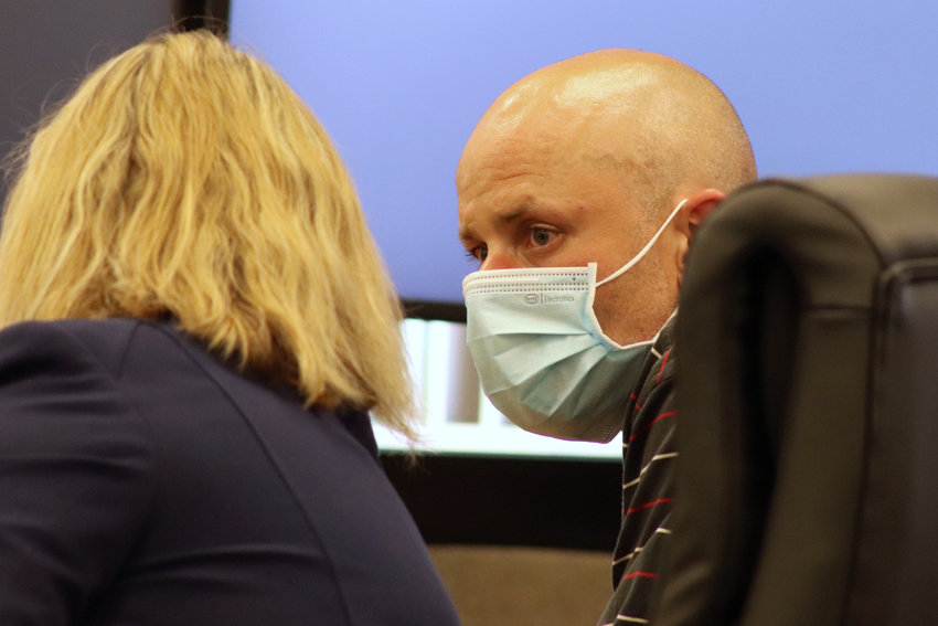 Zachary Hall, 39, of Randle, speaks to defense attorney Rachael Tiller during his preliminary hearing in Lewis County Superior Court on Tuesday.