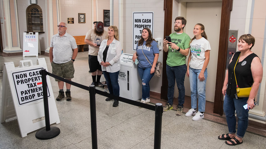 Visitors watch and react as election results appear on screens in August 2022 at the Lewis County Courthouse in Chehalis.