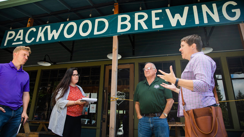 Lewis County Senior Long Range Planner Mindy Brooks, far right, and Commissioner Lee Grose talk with representatives from U.S. Congresswoman Jamie Herrera Beutler&rsquo;s and Senator Maria Cantwell&rsquo;s offices Thursday outside the Packwood Brewing Co.