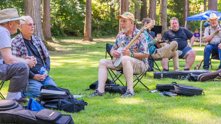 Finn Posner, of Tumwater, talks about his banjo at Winolequa Memorial Park last year in Winlock.