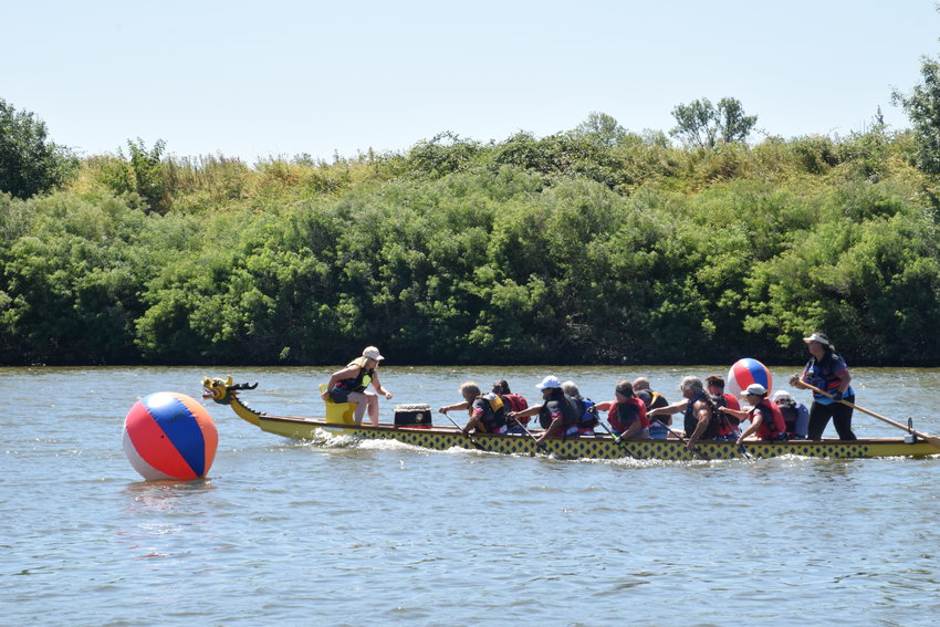 One of many dragon boats crosses the finish line during the Paddle for Life races on Lake River in Ridgefield on Aug. 6.