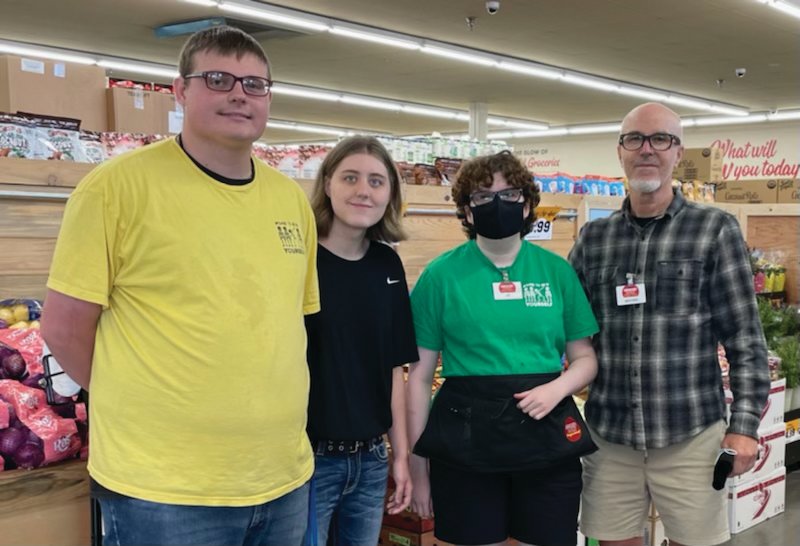 Grocery Outlet co-owner Michael Morgan (far right) poses with some of his employees. About 20 percent of his workforce have some form of disability. He calls hiring those with disabilities &ldquo;the right thing to do.&rdquo;