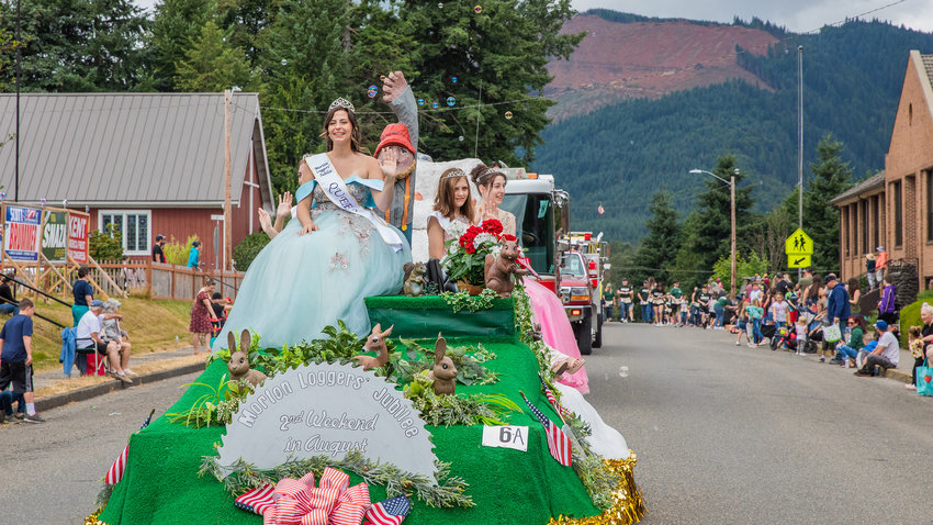 Morton Loggers&rsquo; Jubilee Queen McKenna Mathews waves alongside royalty on a float Saturday in downtown Morton.