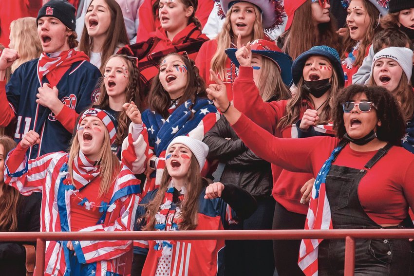 Tornado fans cheer during a game while sporting red, white and blue attire at a previous football game in Yelm.