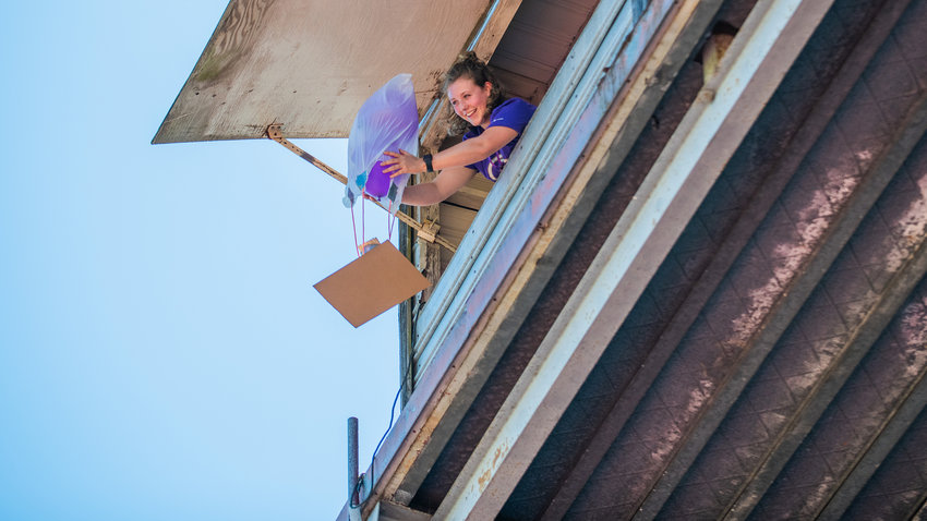Grace O&rsquo;Connor, a University of Washington staff member, smiles while dropping STEM student projects from the press box above Bearcat Stadium Tuesday in Chehalis.