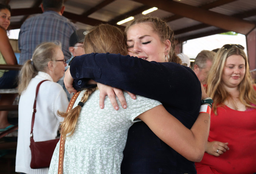 Clara Price of Adna FFA shares a tearful embrace after her 102-pound goat sold for $23 per pound at the Junior Livestock Sale at the Southwest Washington Fairgrounds on Friday &mdash; well above her goal-price of $17 per pound. &ldquo;I&rsquo;m so over the moon,&rdquo; she told The Chronicle. Price, who graduated this year, travels to Utah on Saturday for college.