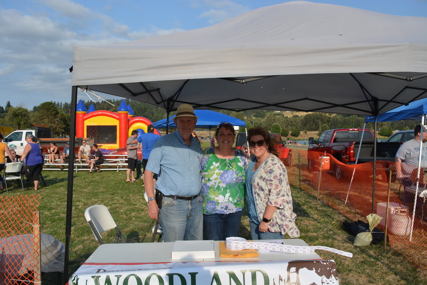 From left to right, Tom Golik, Tracy Coleman and Kathy Morrison, who helped organize Hot Summer Nights in Woodland on Aug. 19, pose for a photo.