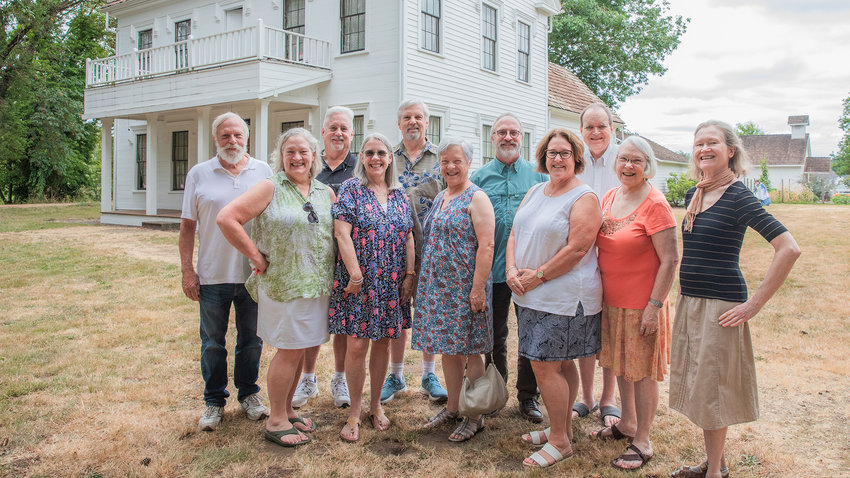 From left, Greg Gerhard, Marci Servizi, Kurt Gerhard, Lisa Miller, Loren Gerhard, Katy Carter, Andy Gerhard, Paula Gatzemeier, Roy Borst, Gretchen McCarthy and Mary Anne Borst smile for a photo in front of the Borst Home in Centralia Saturday afternoon after taking a tour of surrounding structures.