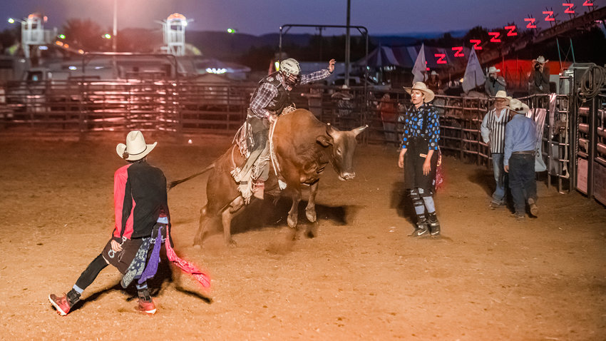 Jace Catlin, of Toledo, rides a bucking bull during a rodeo at the Southwest Washington Fairgrounds Saturday evening.