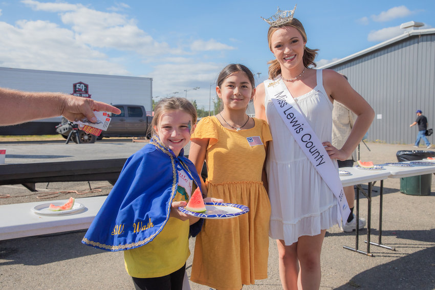 Ali Thomas, 10, of Kelso, center, poses for a photo after winning the 13 and under watermelon eating competition at the Southwest Washington Fairgrounds on Saturday.